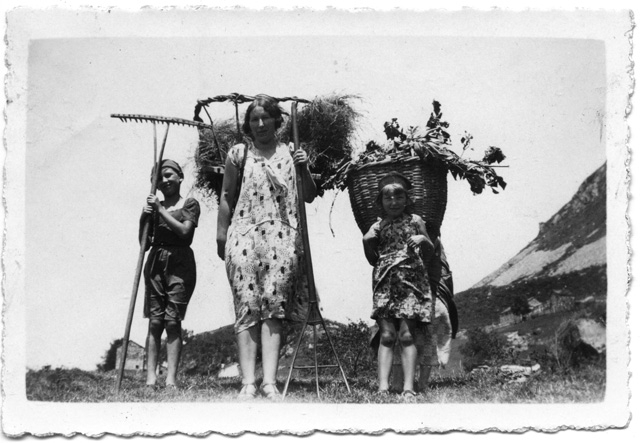 Ritratto di donna e bambini durante la fienagione