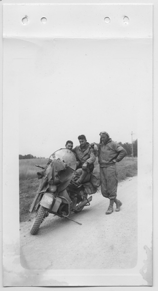 Tre soldati americani in posa accanto a una motocicletta