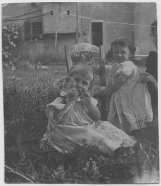 Due bambine sedute in giardino