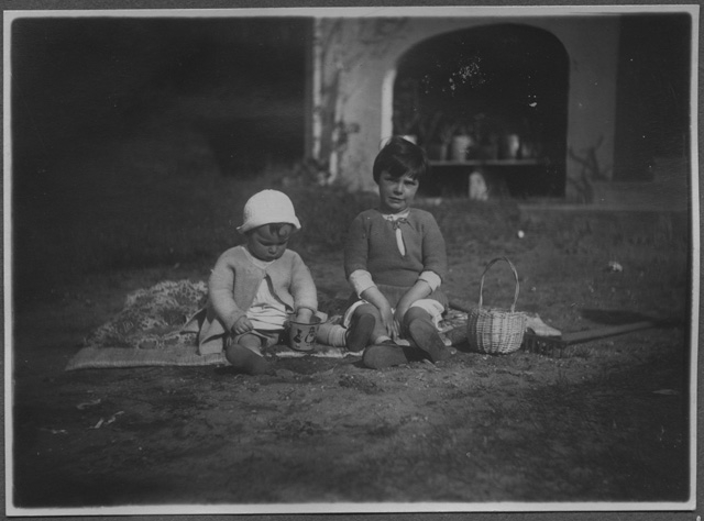 Due bambine sedute nel giardino di casa Rossi a Biolda