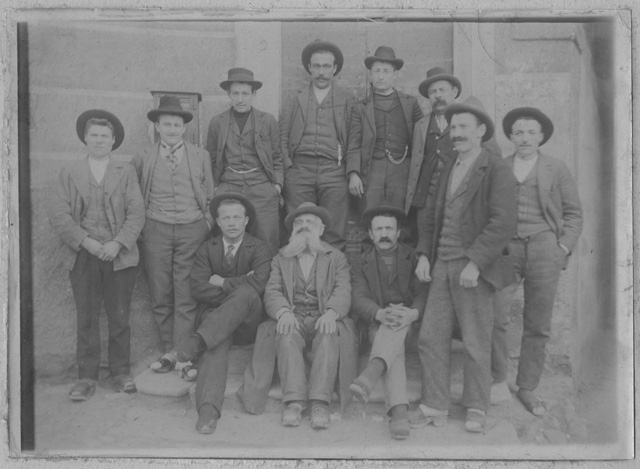 Uomini in posa sulla piazza di Bidogno