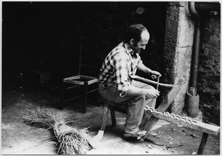 Seggiolaio mentre ripara una sedia