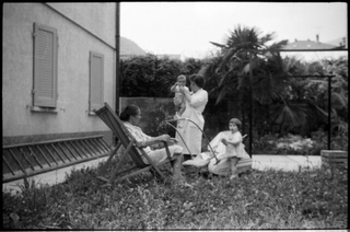 Ritratto di Anna e Lucia Besomi con due bambini in giardino a Tesserete
